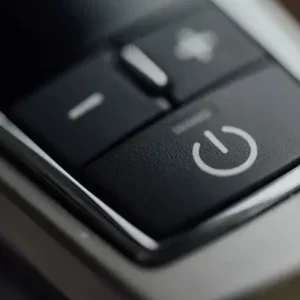 Close-up of a black power button with the universal power symbol.