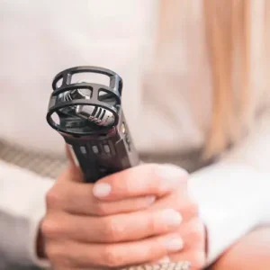 Close-up of hands holding a black handheld audio recorder.